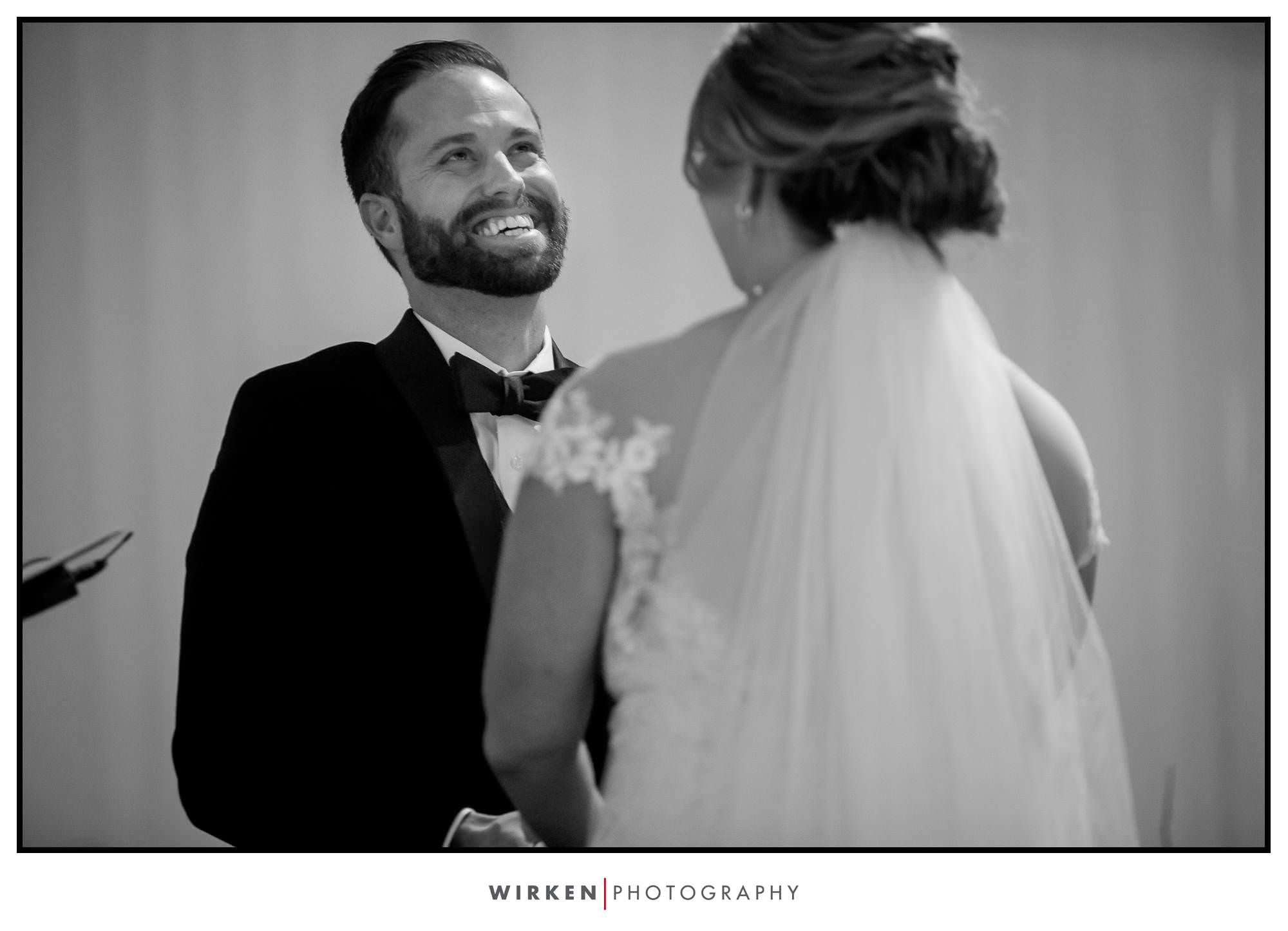 Ryan laughs during their wedding ceremony at the Gallery Event Center
